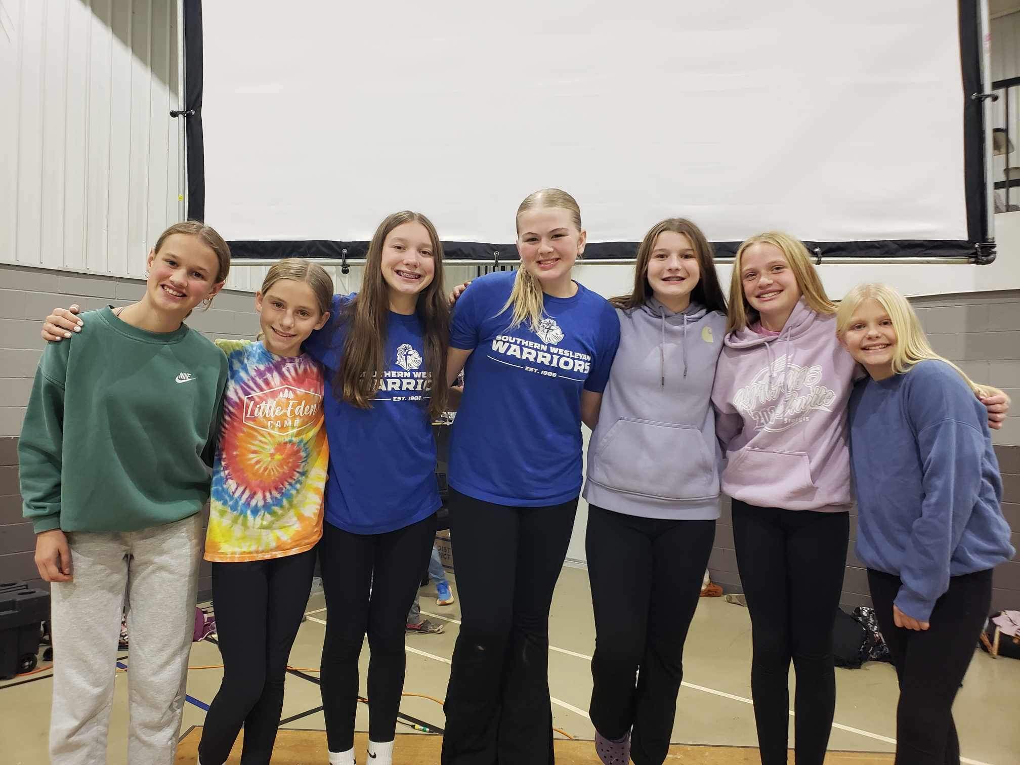 girls posing on stage